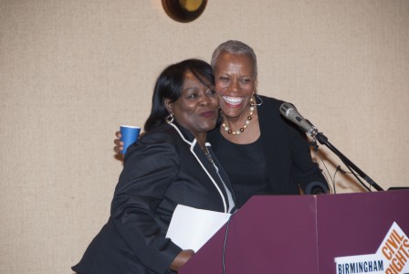 Lajuana Bradford, chairwoman of the BCRI board of directors, left, hugs new BCRI CEO Andrea Taylor after introducing her at a press conference. (Billy Brown/Alabama NewsCenter)