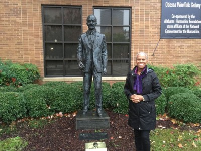 Andrea Taylor stands next to the Shuttlesworth exhibit at the Civil Rights Institute.