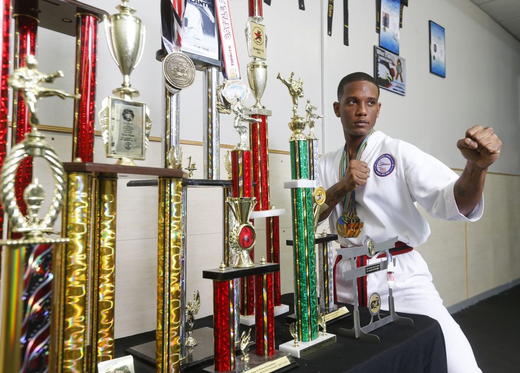 Justin Nalls, who is a member of a US Martial Arts team and who recently won 3 individual gold medals at the world championship in South Africa, poses for a portrait with his trophies.  (Gary Cosby Jr./Tuscaloosa News)