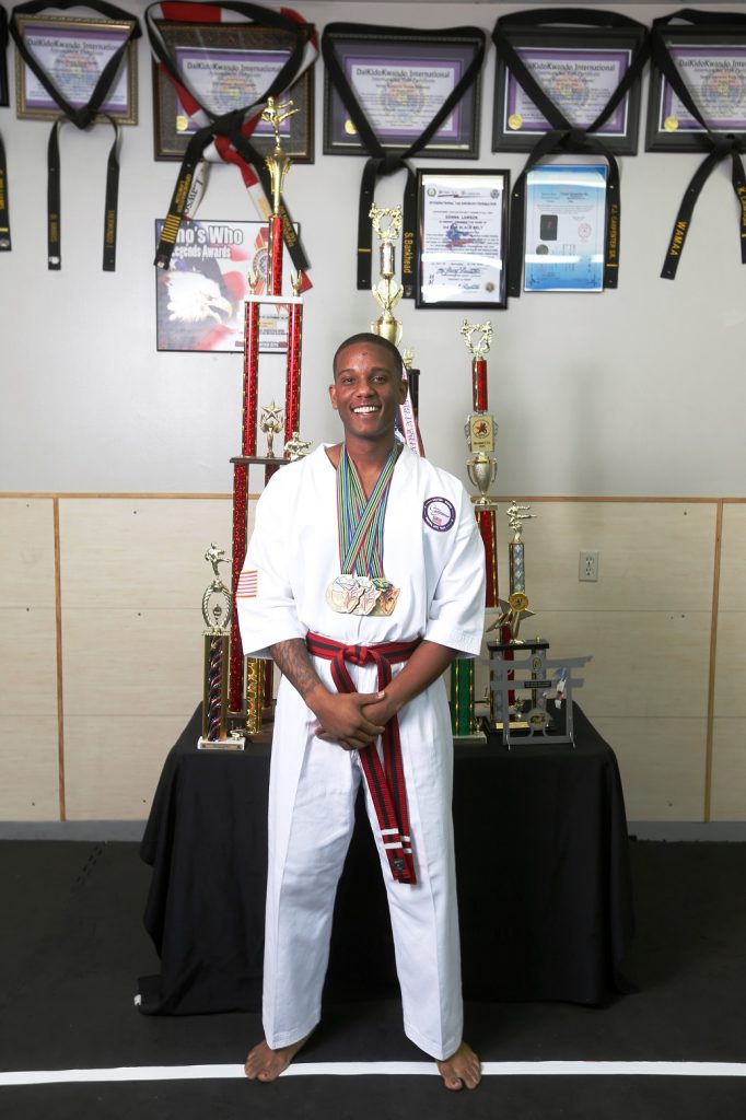 Justin Nalls, who is a member of a US Martial Arts team and who recently won 3 individual gold medals at the world championship in South Africa, poses for a portrait with his trophies.  (Gary Cosby Jr./Tuscaloosa News)