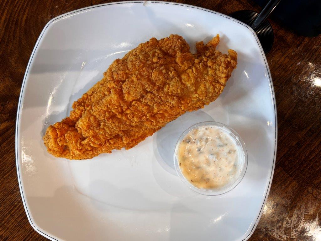 The catfish at Yo' Mama's is great with the house-made tartar sauce, or you can add it to your shrimp and grits. (Michael Tomberlin / Alabama News Center)