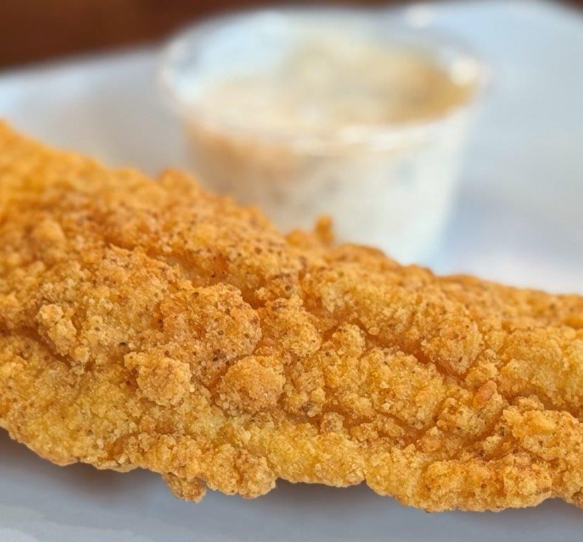 The catfish at Yo' Mama's is great with the house-made tartar sauce, or you can add it to your shrimp and grits. (Susan Swagler / Alabama News Center)