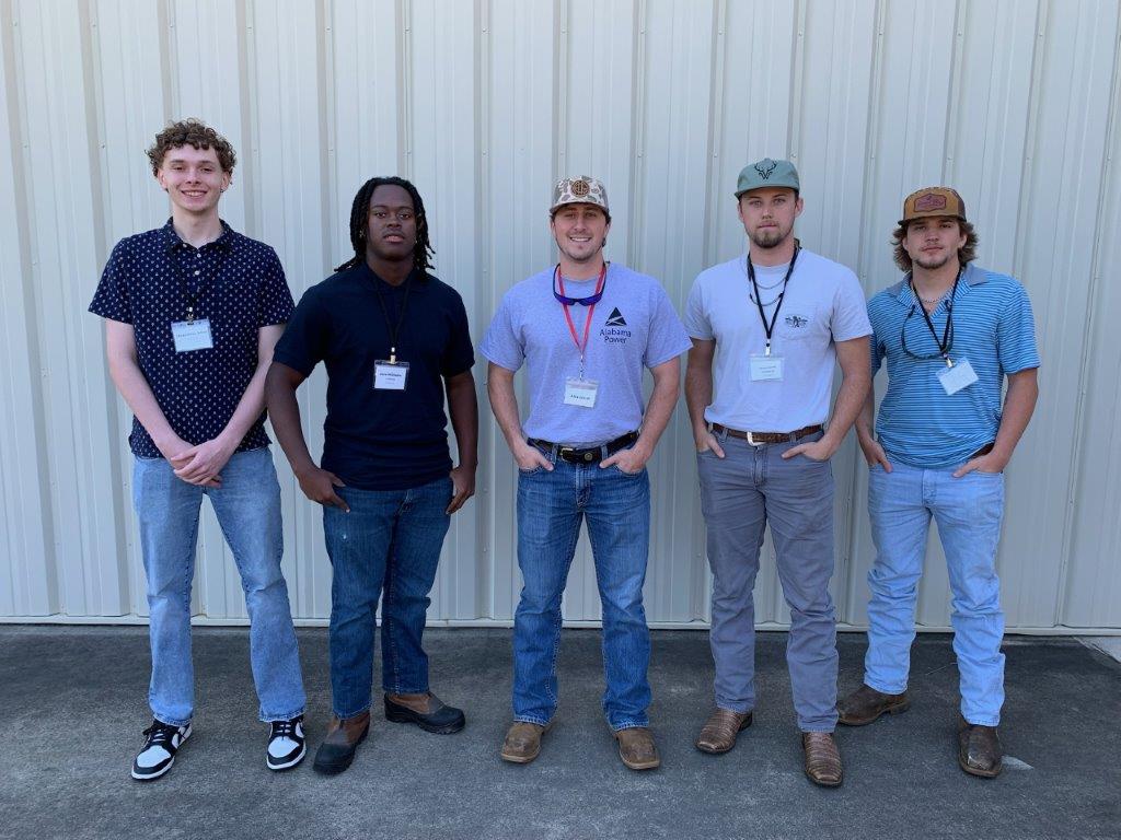 Alex Welsh, center, Alabama Power engineer, leads a group of students at lineworker career day in Headland. (Teisha Wallace / Alabama News Center)